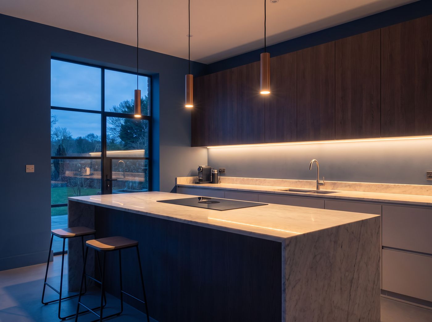 Modern renovated kitchen with custom cabinetry and stone countertop